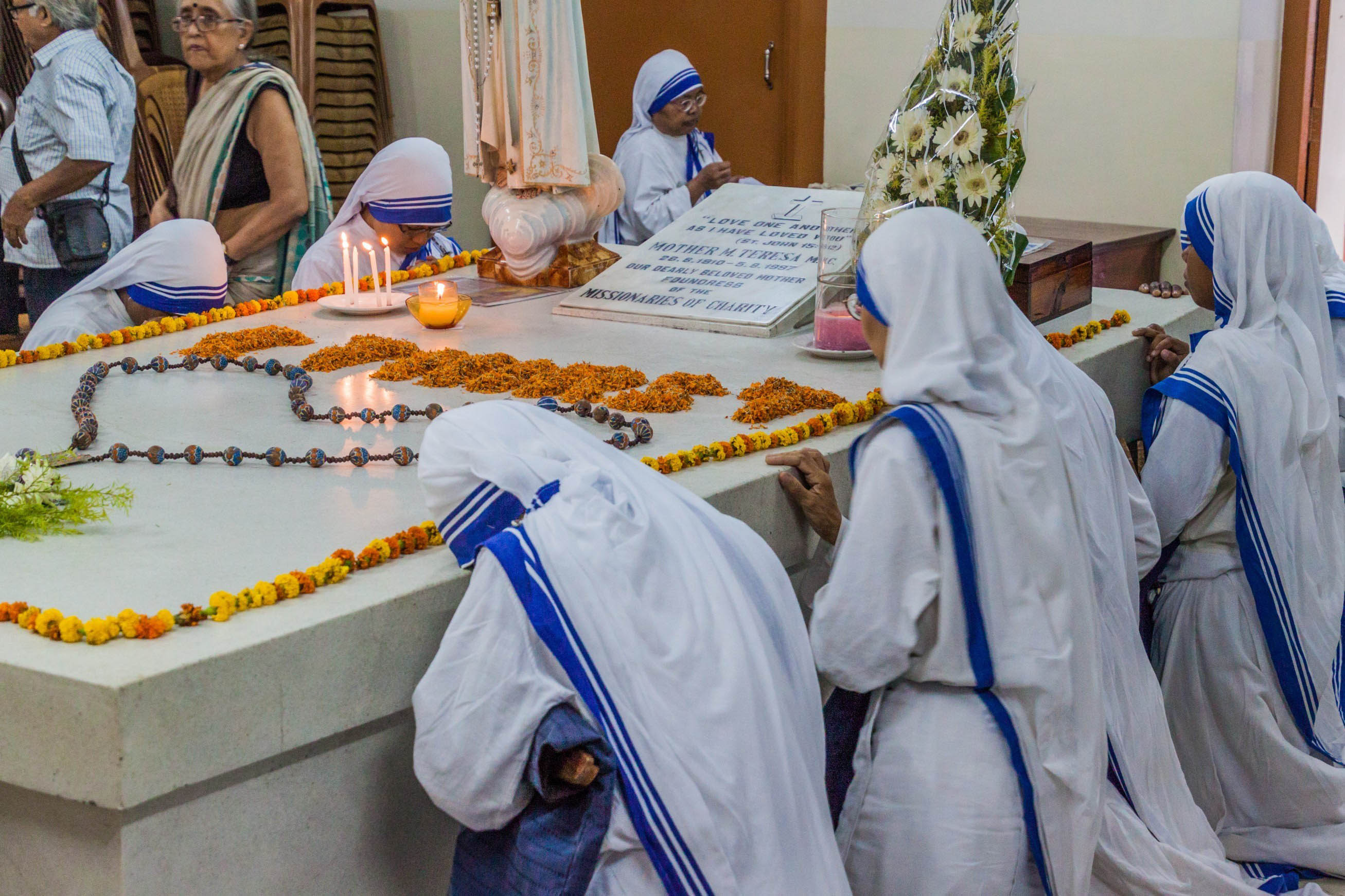 KOLKATA, INDIA - OCTOBER 30, 2016: Sisters of The Missionaries of Charity pray at Mother Teresa tomb in Mothers House in Kolkata, India.